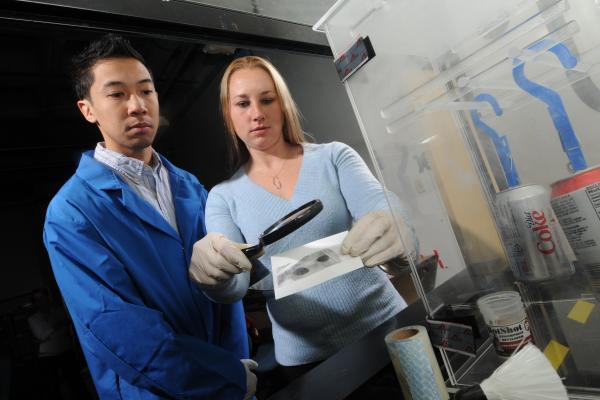 Forensic science students examine fingerprints