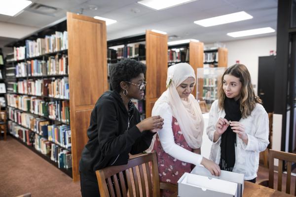 Alexis Bracey (left), Ayman Fatima (center) and Elizabeth Perez-Garcia (right) were three of the students who started with the project in summer 2017, bringing with them their backgrounds in criminology, public health, global affairs and other fields. Photo by Evan Cantwell.