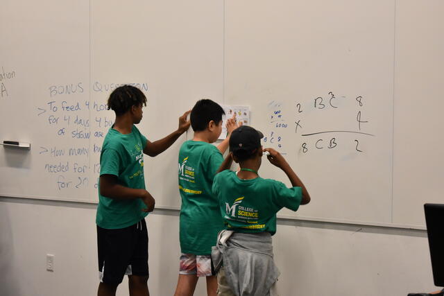 MMO Camp Students working at white board