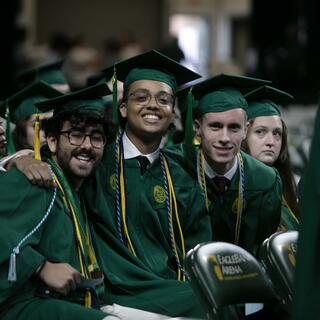 Three students smile at the College of Science Degree Celebration 2024