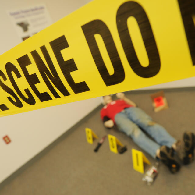 Crime Scene House room with crime scene tape around a dummy