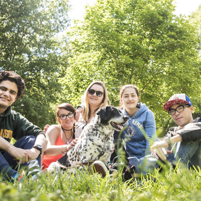 Students on campus with dog