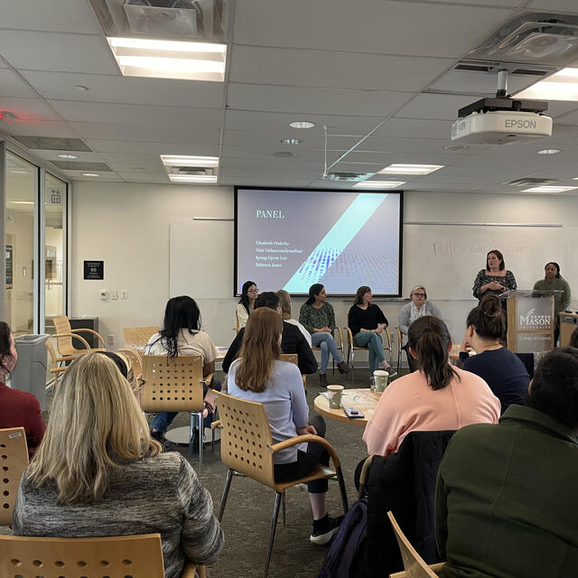 group of people sitting in a classroom viewing a presentation 