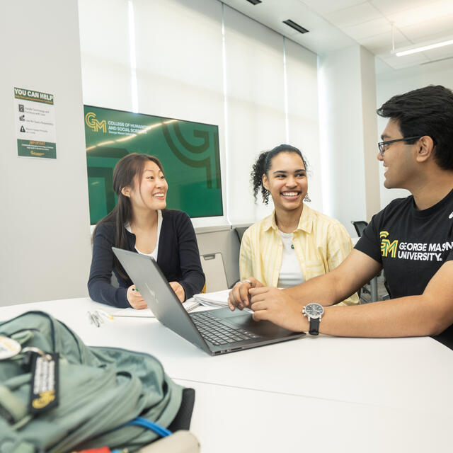 Students at table with laptop