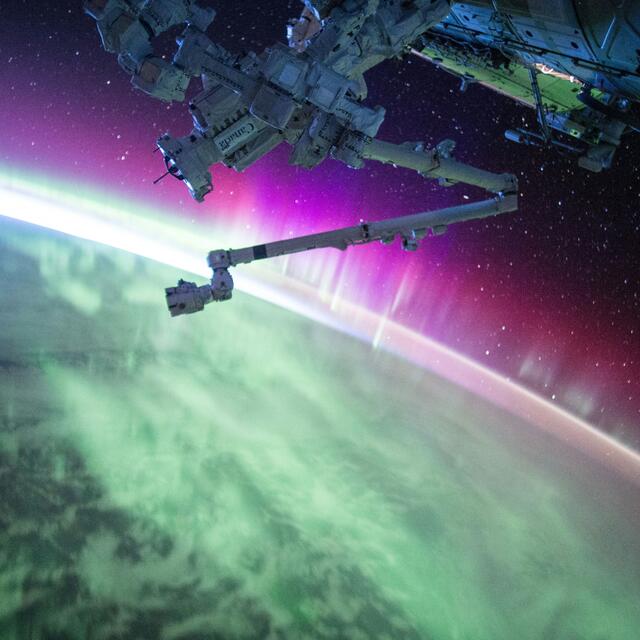 Satellite in space taking image of earth and aurora borealis's 