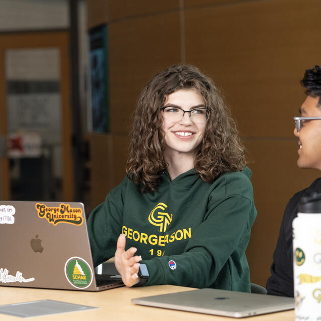 Students with laptop on campus