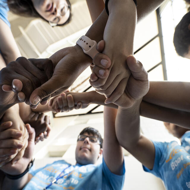 Students linking arms as part of the Global STEM Scholars Program