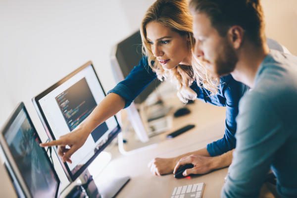 Two people working on computer