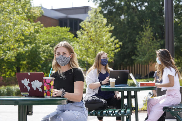 Students on campus wearing masks