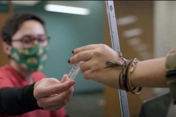 Women handling saliva test