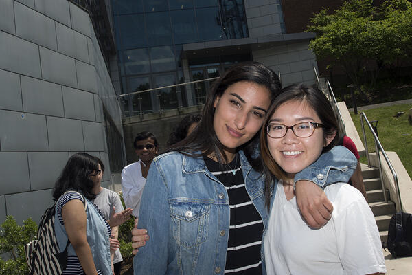 Two COS students in front of Exploratory Hall