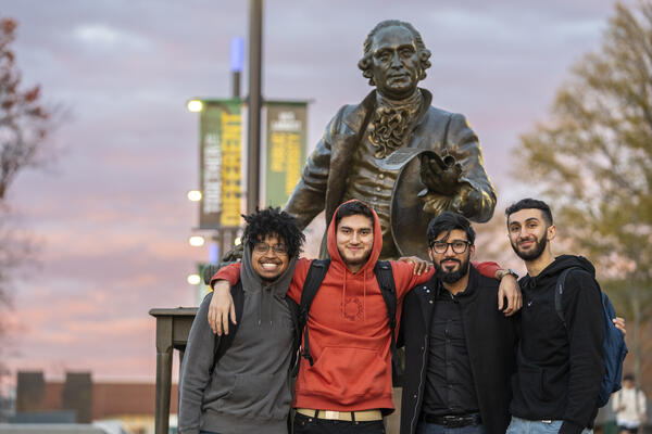 Students in front of George Mason statue