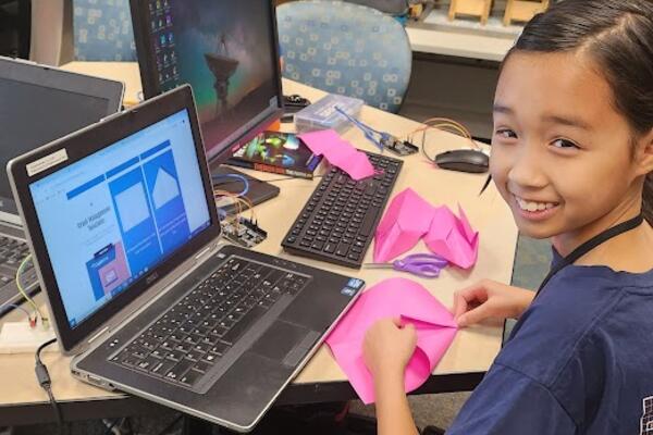 A happy camper designs an experimental glider.