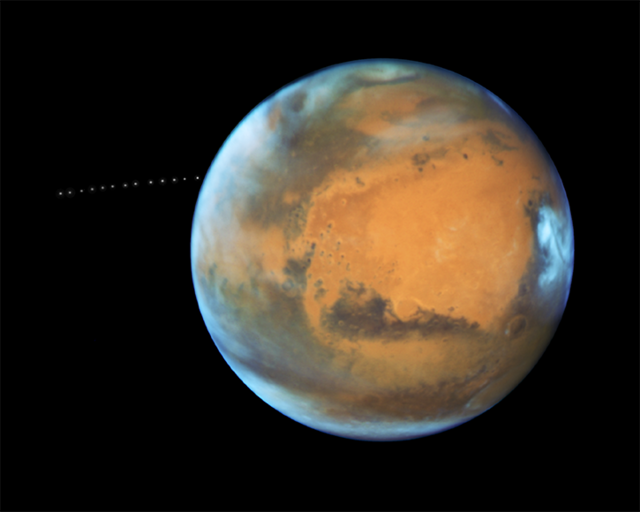 While photographing Mars, NASA’s Hubble Space Telescope captured a cameo appearance of the tiny moon Phobos on its trek around the planet in 2017. Photo courtesy of NASA.