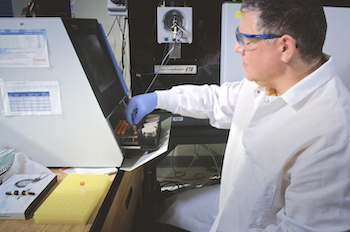 Mason researcher Paul Russo loads saliva samples into a mass spectrometer in the CAPMM laboratory. Photo provided.