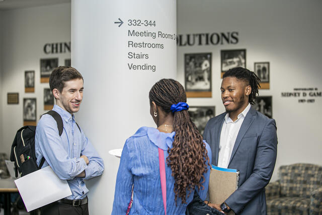Students speaking to one another at Mason