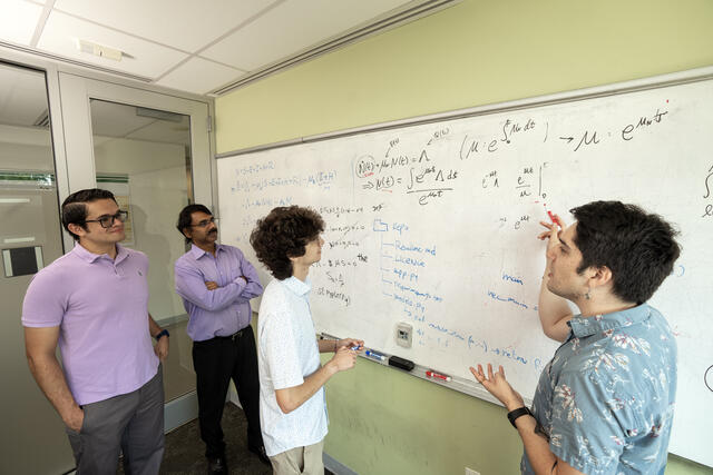 Mason professor Padhu Seshaiyer (second from left) and Mason PhD student Alonso Ogueda-Oliva (far right) work with SIAM-Simons program participants Diego Gonzalez and Adan Baca.
