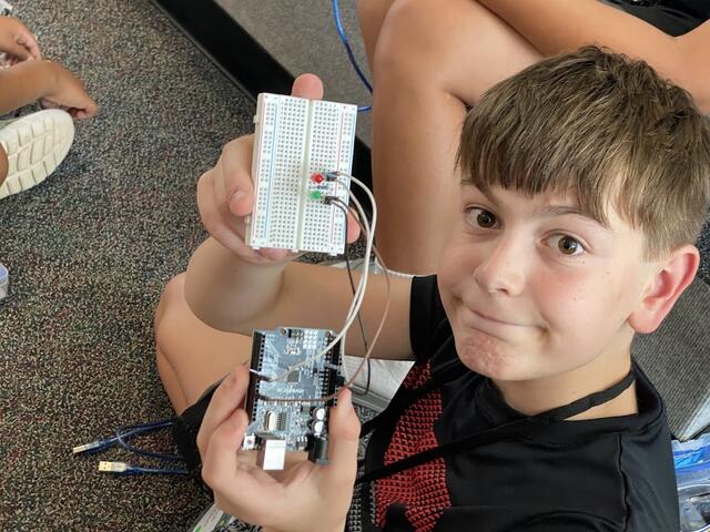 A camper presents their construction of an LED transmitter using their Inventr.IO "30 Days Lost in Space" Arduino Kit.