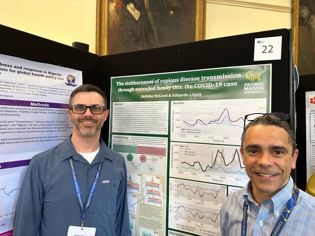 McLeod stands with López in front of their research poster at the conference. 