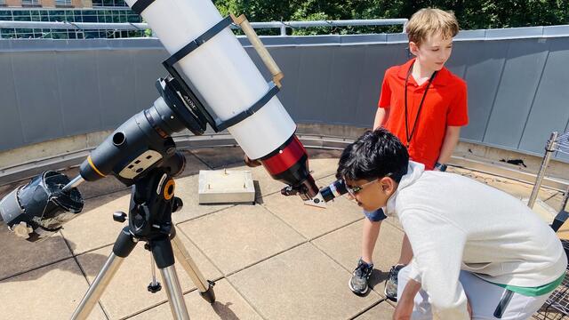 A camper looks through the Solar Telescope at the Sun. It was very hot that day, and a bit unnerving to see the source of that heat magnified so much!