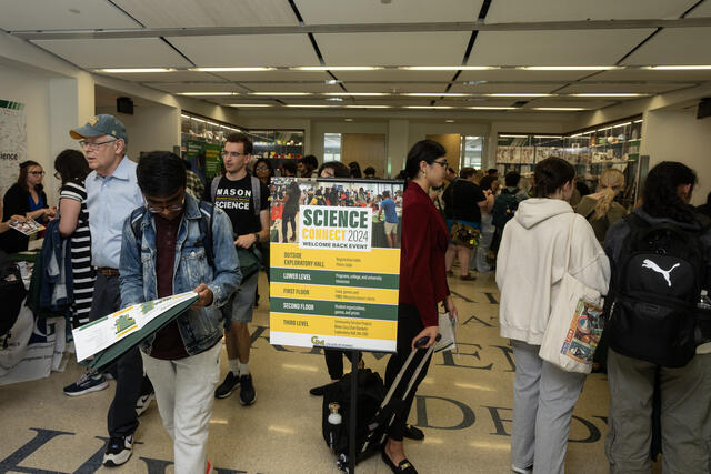 Students traveling through Exploratory Hall to meet departments and learn about resources at George Mason