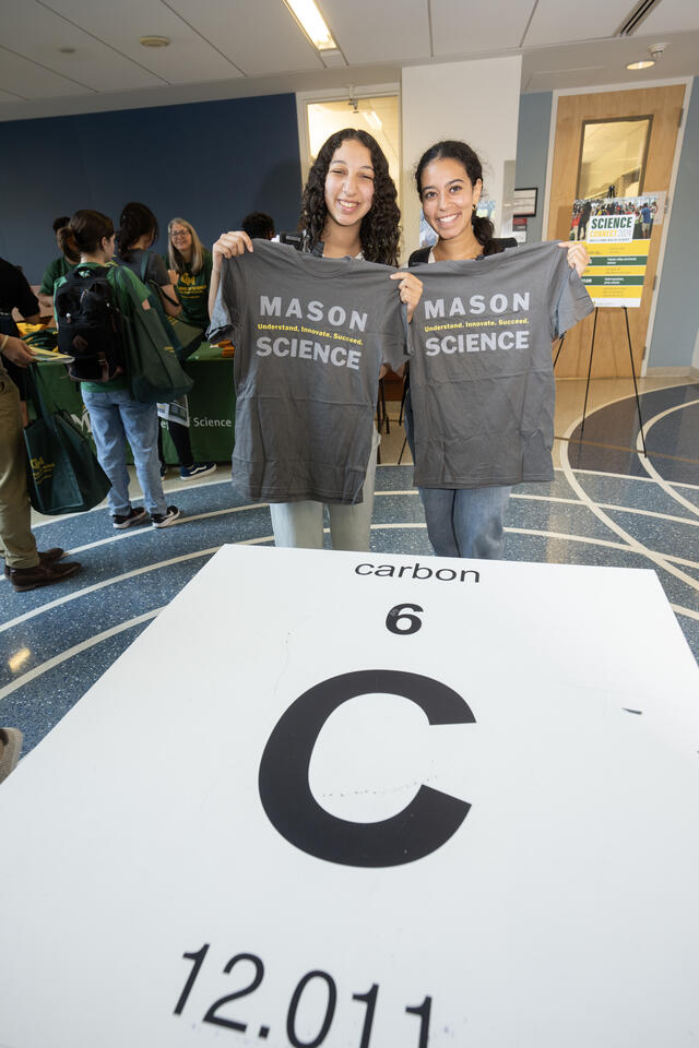 Two students hold up their new tshirts at ScienceConnect 2024