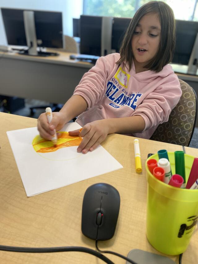 A camper prepares a recreation of Venus to use the scaled Solar System.