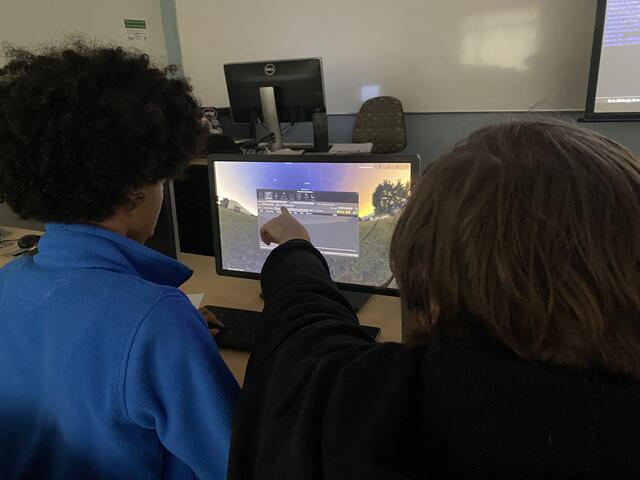 A Counselor and Camper view upcoming celestial events in the Stellarium Planetarium.