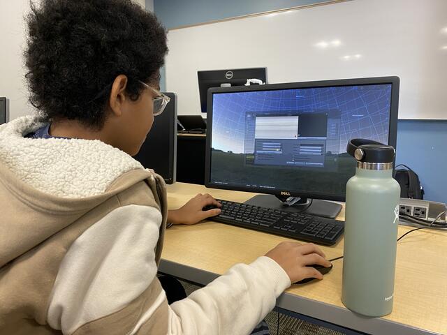 A camper uses the virtual planetarium to see the moons of Jupiter.