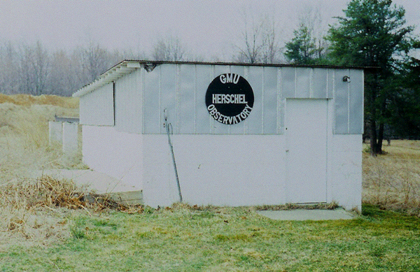 White building with sign reading "GMU Herschel Observatory"
