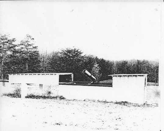open roofed building with telescope