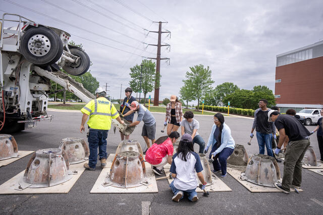 Students build an artificial reef with Jesse Howe, assistant director of Coastal Conservation Association Maryland, on the Science and Technology Campus. Photo by Evan Cantwell/George Mason University