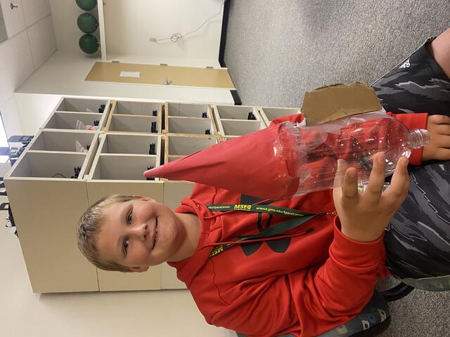A camper poses with their water bottle rocket.