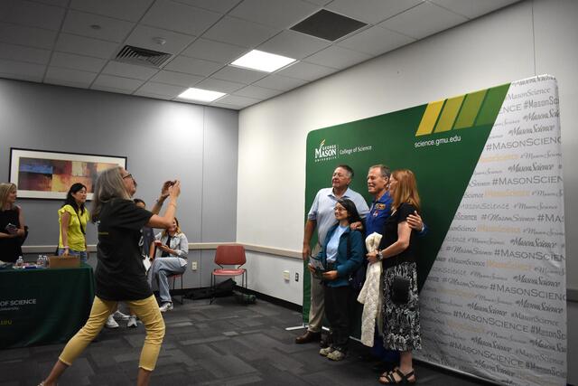 Space Day attendees getting their photo with Retired NASA astronaut Captain Robert “Hoot” Gibson, USN 