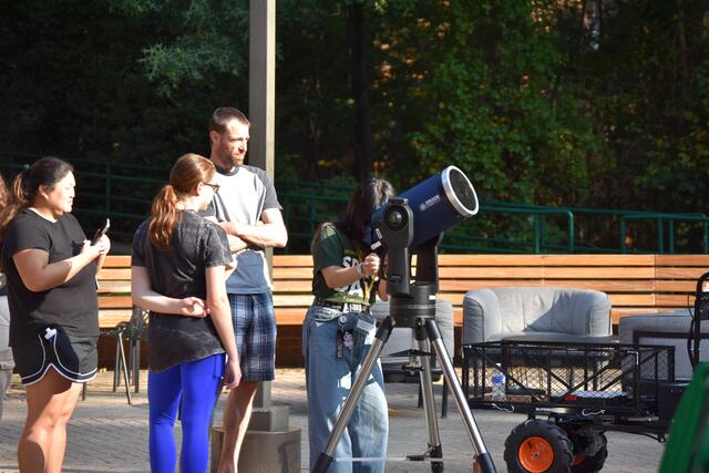 Participants looking through the college's solar telescopes. 