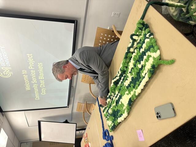 Dean Cody W. Edwards helps makes blankets to donate to local shelters at the 2025 ScienceConnect.