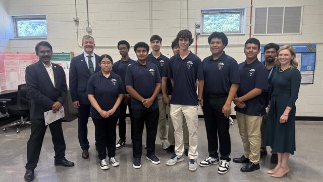 Padhu Seshaiyer, Cody Edwards, and Meghan St. George stand with students from the lab school ribbon cutting. 