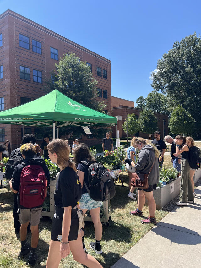 Attendees of ScienceConnect 2025 outside on the lawn. 