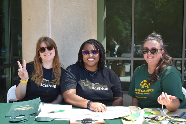 Three Mason Science staff ready to sign in students to ScienceConnect 2025