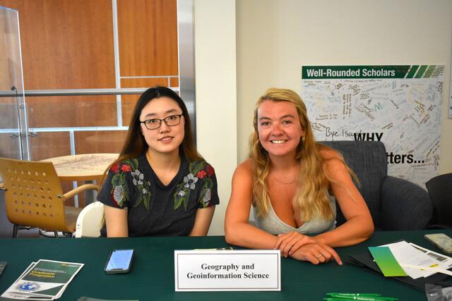 Two individuals at the GGS table waiting for students at ScienceConnect 2025