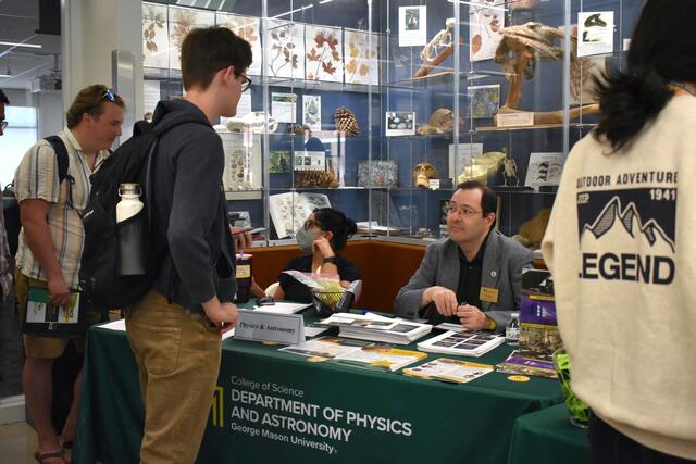 Students visiting the Physics and Astronomy table at ScienceConnect 2025