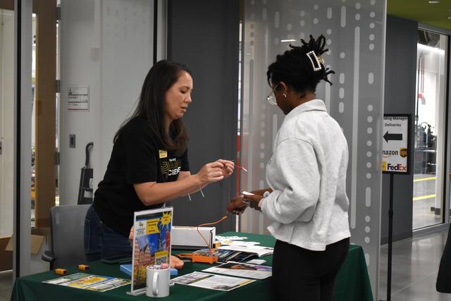 Participant visiting the neuroscience table at ScienceConnect 2025