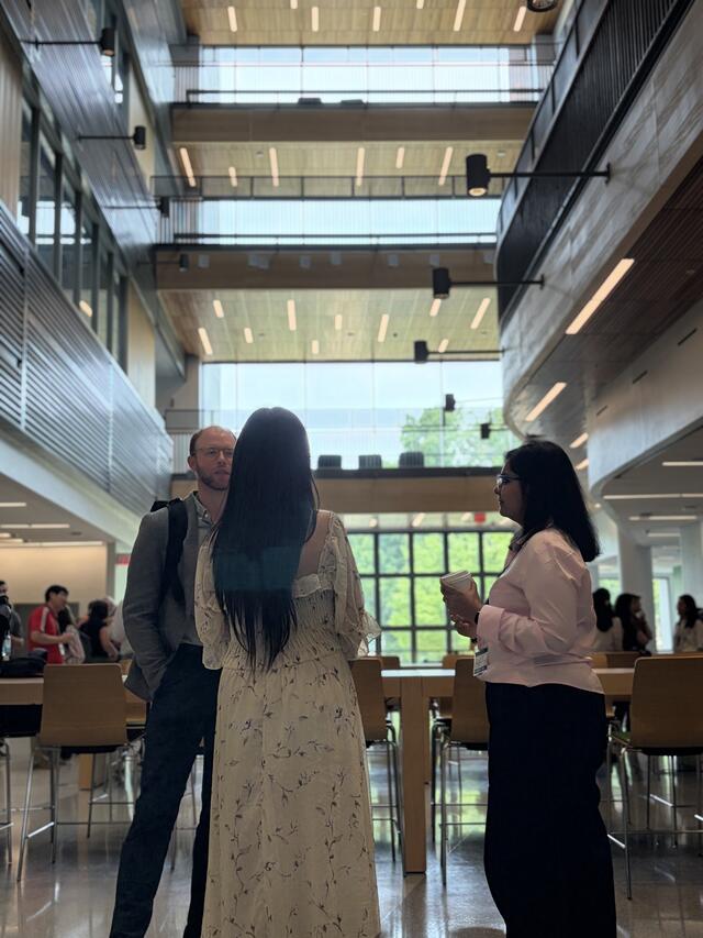 AIRDC 2026 attendees chatting between sessions. 