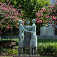 "Communitas" by artist Azriel Awret framed by crape myrtles on Holton Plaza, Fairfax Campus.