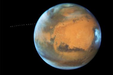 While photographing Mars, NASA’s Hubble Space Telescope captured a cameo appearance of the tiny moon Phobos on its trek around the planet in 2017. Photo courtesy of NASA.