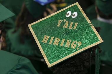 Graduation cap designed by a student that says "Y'all Hiring?"