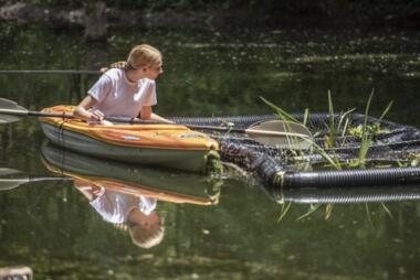 Mason freshman Kennedy Ream installed a floating biological island to combat the algae problem in the pond behind her high school in Logansport, Indiana. Photo by Tony Walters. Courtesy of Pharos Tribune.