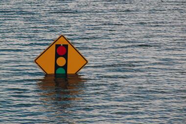 Flooded traffic sign. Photo by Kelly Sikkema on Unsplash