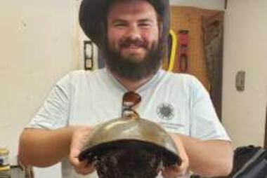Picture of Ryan McIntyre holding a horseshoe crab