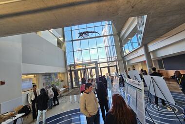 Photo of Exploratory Atrium, filled with people. There's a whale skeleton in the background.